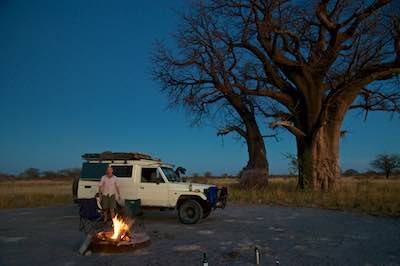 Camping by campfire with Land Cruiser